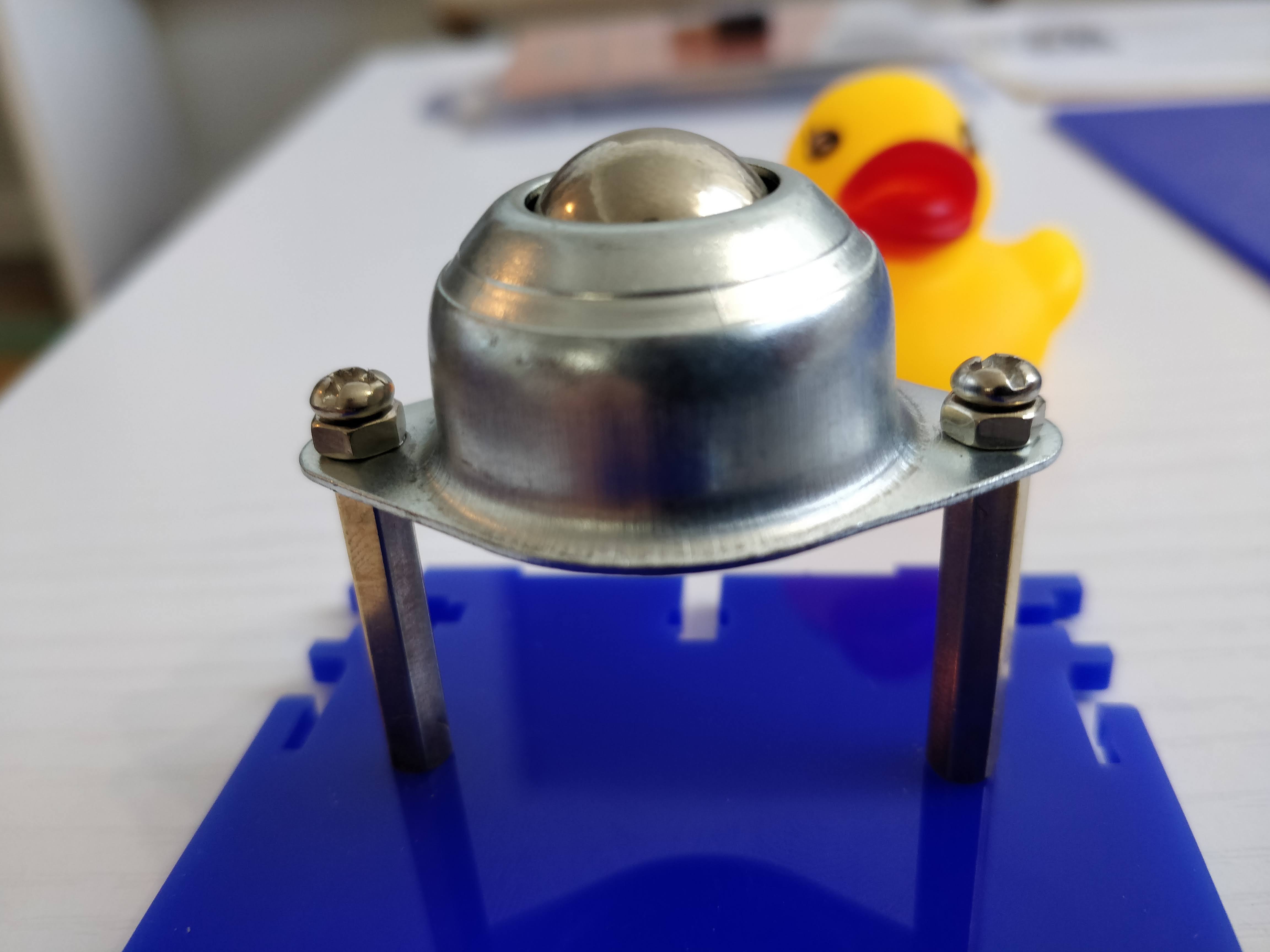 Spare nuts being used to mitigate tolerances between the omni wheel and stand-offs.